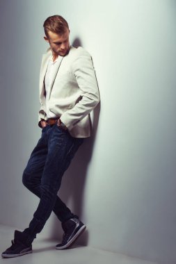 Genç yakışıklı erkek modeli Studio trendy kıyafetler giyiyor. Stüdyo çekimi