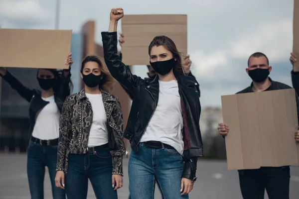 Diverse group of people protesting with blank sign. Protest against human rights, abuse of freedom or racist beliefs