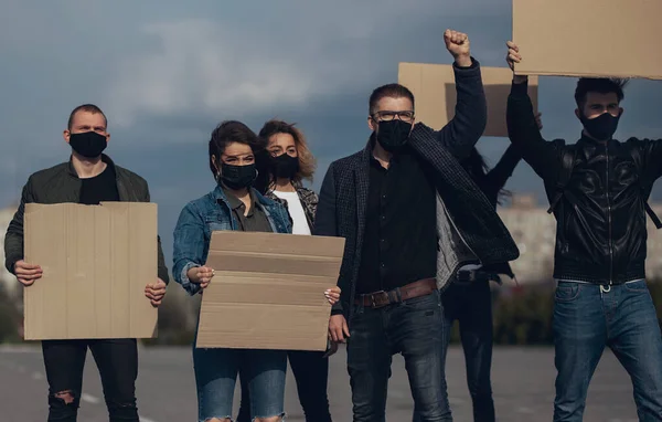 Diverse group of people protesting with blank sign. Protest against human rights, abuse of freedom or racist beliefs