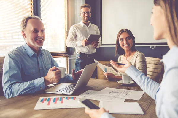 Business People Using Gadgets Discussing Affairs Smiling While Working Office Stock Picture