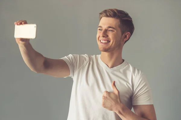 Handsome guy with gadget — Stock Photo, Image