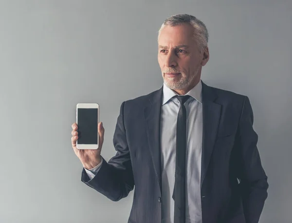Handsome mature businessman with gadget — Stock Photo, Image
