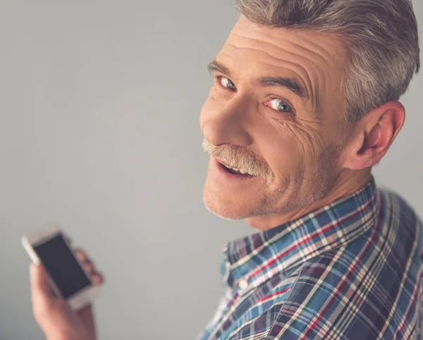Mature man with gadget — Stock Photo, Image