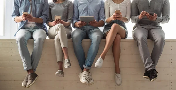 Young people with gadgets — Stock Photo, Image