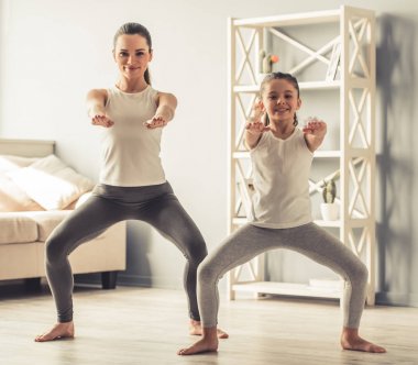 Anne ve kızı yoga yaparken
