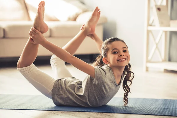 Smiling Little Girl Doing Yoga Pose Home Adorable Happy Child Stock Photo  by ©vadimphoto1@gmail.com 211089754