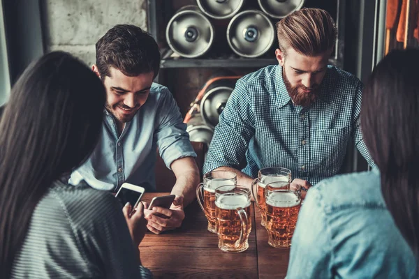 People at pub with phone