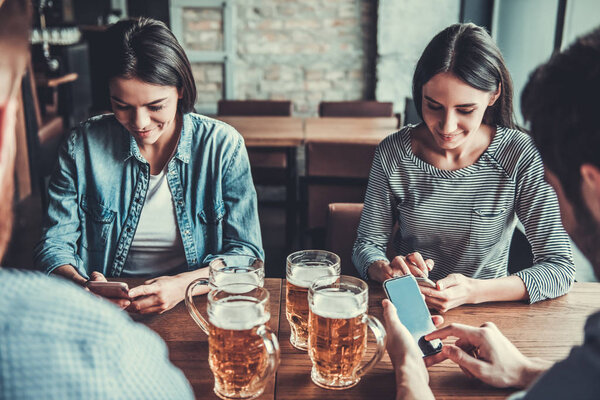 People at pub with phone