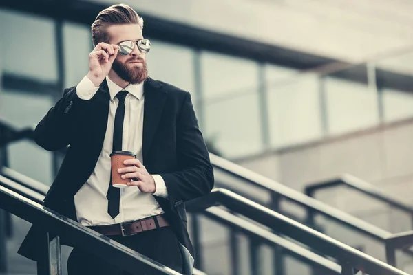 Hombre Negocios Barbudo Guapo Traje Clásico Gafas Sol Está Sosteniendo — Foto de Stock