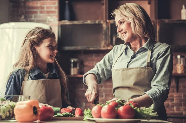 Grandma and granddaughter in kitchen