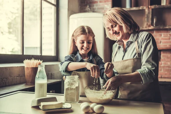 Grandma and granddaughter in kitchen