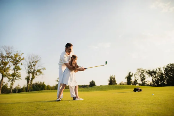 Prudkou ránu na ples golfovou holí. dívka se jí nejprve přístupů v golfu — Stock fotografie