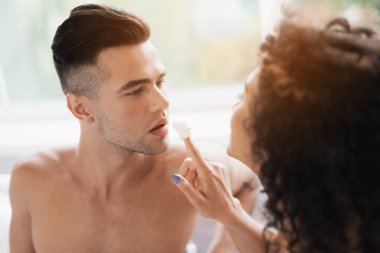 Kız onun parmak ile krem şanti bulaşmış ve adam, parmağını yaladı.