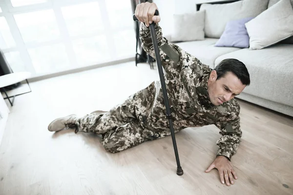 Man Uniform Lying Floor Fell Crutch His Hand Hurts Large — Stock Photo, Image