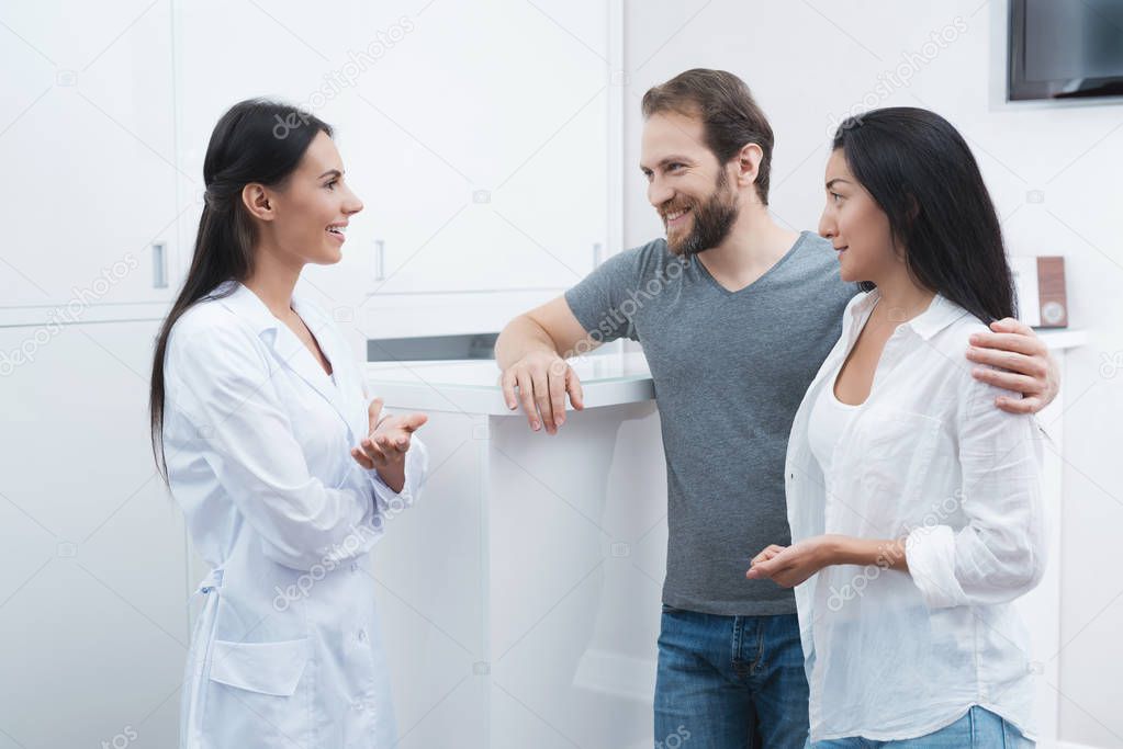 A man and a woman came to see a dentist. The receptionist fills in the form and interviews the patients.