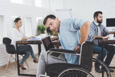 Disabled person in the wheelchair works in the office. He feel desease. clipart