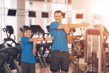 Baba ve oğul aynı giysileri içinde jimnastik salonu. Baba ve oğul sağlıklı bir yaşam tarzı yol.