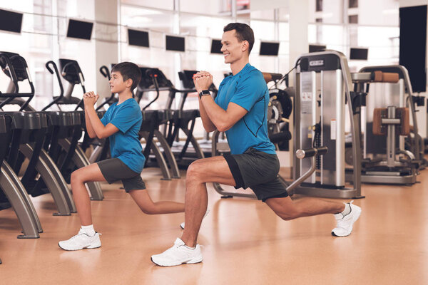 Dad and son in the same clothes in gym. Father and son lead a healthy lifestyle.