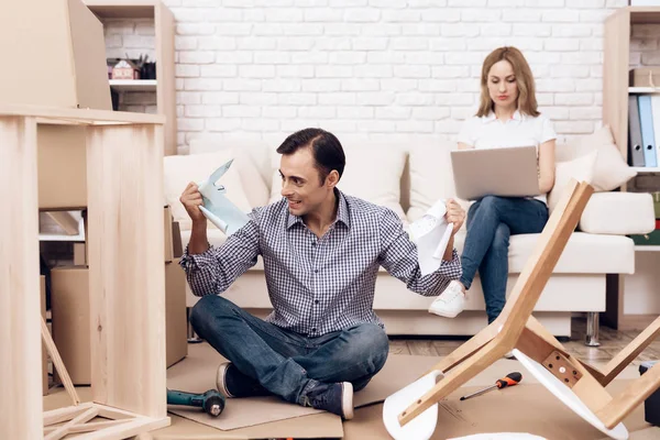 Mannen handyman är engagerad i montering av möbler. Reparatör är engagerad i reparera möbler. — Stockfoto
