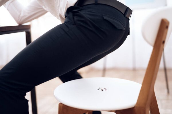 On the chair are drawing pins.