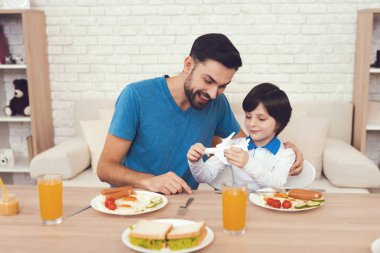 Bir adam oğluyla vakit geçiriyor. Çocuğun babası çocuk yetiştirirken devreye girer. Baba oğlu beslenir. Çocuk babasının yanında having kahvaltı.