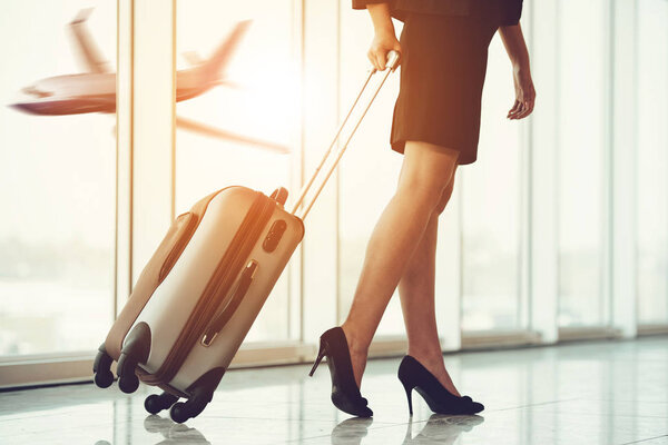 Business Travel. Business people at airport. Airport hall with panoramic windows.