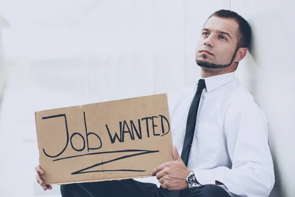 A young man is looking for a job. The guy looks at the job ads. Job wanted. — Stock Photo, Image