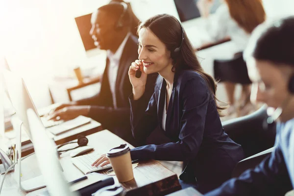 Kaukasische meisje kijkt op het werk in het callcenter. — Stockfoto