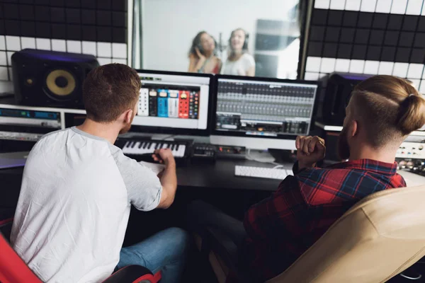 Two Girls Sing Recording Studio Console Two Sound Engineers Sitting — стоковое фото