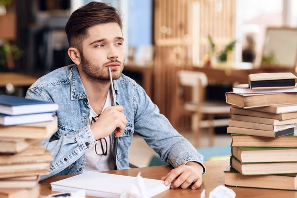 Freelancer homem tomando noteson papel sentado na mesa . — Fotografia de Stock