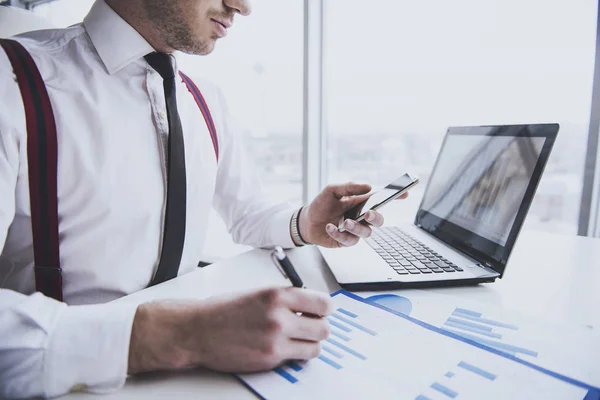 Businessman is using mobile phone at desk in  office — Stock Photo, Image