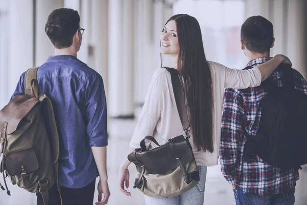 Young attractive students going down the hall  in college. — Stock Photo, Image