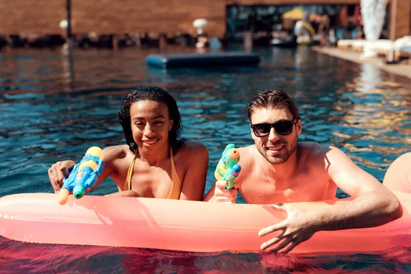 White Guy Black Girl Swimming Water Guns Inflatable Mattress Pool — Photo