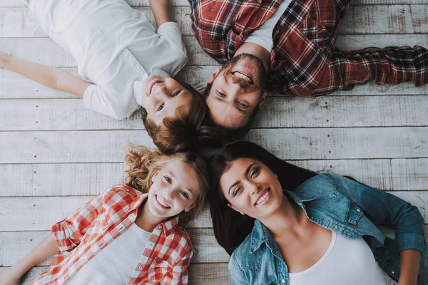 Ansicht von oben. große glückliche Familie liegt in Sternenform zusammen auf dem Boden. — Stockfoto