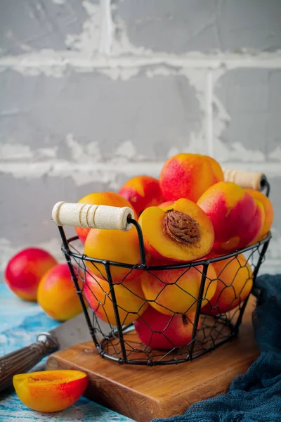Nectarinas frescas de frutas jugosas en rejilla metálica sobre fondo de hormigón azul . — Foto de Stock