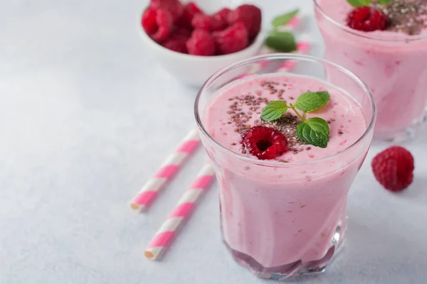 Raspberry smoothie with chia seeds and mint in a glass cup on a gray light stone or concrete background. — Stock Photo, Image