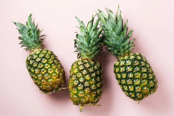Fresh tree pineapple on pink background. Summer concept. Creative flat lay with copy space. Top view.