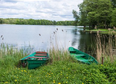 two wooden boats on Lake in Trakai clipart