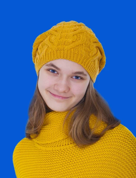 Smiling girl in a yellow sweater — Stock Photo, Image