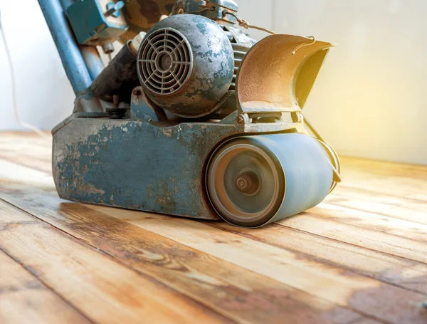 Worker polishing parquet floor with grinding machine — Stock Image Worker polishing parquet floor with grinding machine Stock Image