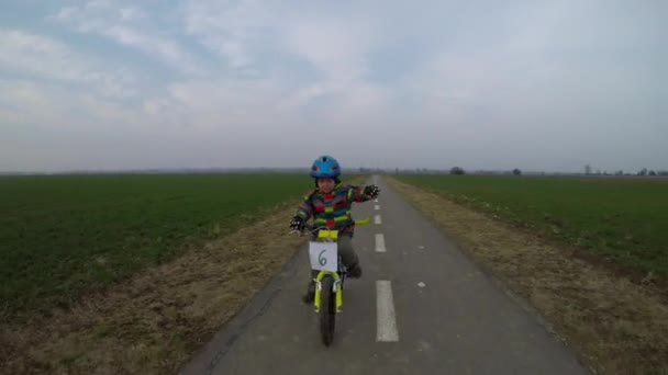 Cute little boy riding a bike. — Stock Video