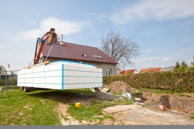 Laying of the swimming pool in the garden of the family house. clipart