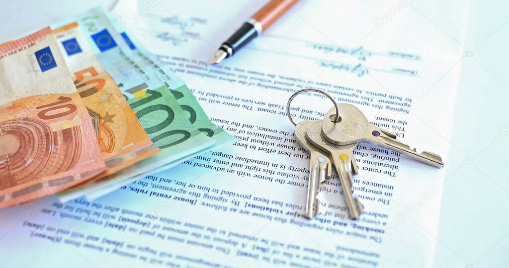 Purchase of property, lease. Against the background of real estate keys and money.