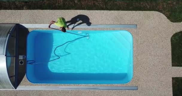 Man Zuigt Reinigt Het Zwembad Seizoensarbeid Vanuit Een Luchtperspectief — Stockvideo