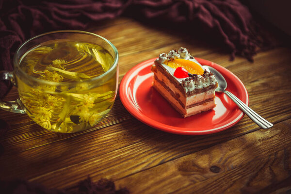 cup of tea and cake on a wooden table