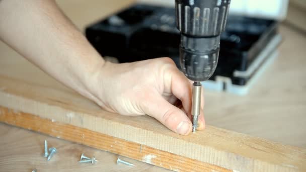 The master screws the screw into the board — Stock Video