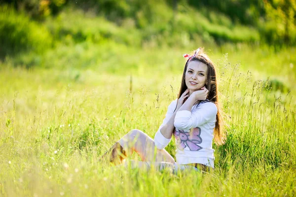 Giovane ragazza è seduta in giardino — Foto Stock
