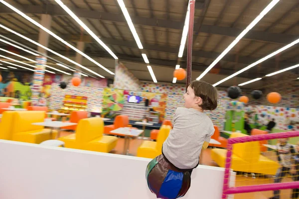 The kid is riding an attraction — Stock Photo, Image