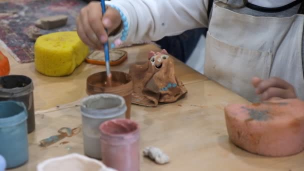 El niño aprende a moldear diferentes tipos de productos de arcilla en un taller de cerámica . — Vídeo de stock