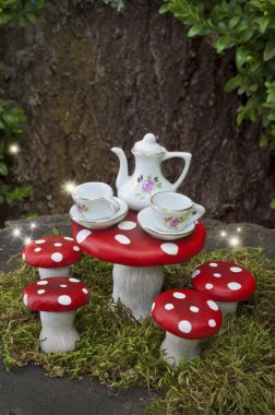 Tea party with fairies in forest with sparks of light clipart
